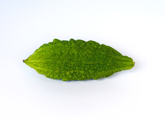Closeup view of bitter gourd over vegetable garden concept on a white background