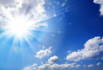 Naklejka na ściany i meble Beautiful shiny blue sky cloudscape image with sun and beam of light