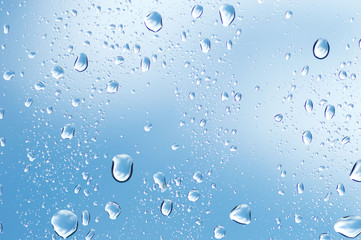 Water drops of rain on blue glass background