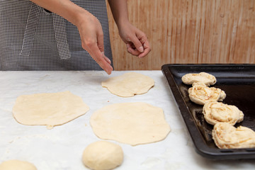 The hostess prepares the pies in the kitchen