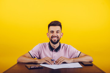 a young man and beard man, makes notes in the book and phone in the hand, facial expressions, glad, tired and ingenious