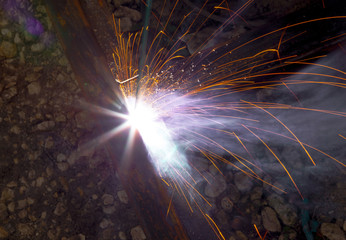 Sparks from welding at a construction site as a background