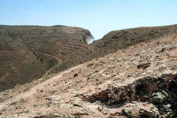 clouds pushing against the mountains on the island of Lanzarote