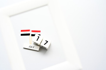 July 17 Wooden calendar and Iraq Flag Concept Iraq national day