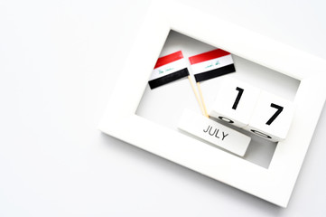 July 17 Wooden calendar and Iraq Flag Concept Iraq national day