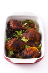 Roasted tandoori chicken with herbs isolated on white background
