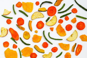 Top view of dried fruit and vegeabl chips. Healthy snack flat lay. Natural organic colorful food on white background.