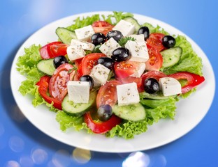 Greek salad with fresh vegetables on background