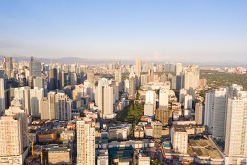 Naklejka na ściany i meble Cityscape of Makati, the business center of Manila, view from above. Asian metropolis in the morning, top view. Skyscrapers and residential neighborhoods, the capital of the Philippines. Modern city.