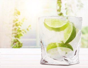 Glass of water  and lime on  background