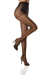 Cropped half-turn shot of woman's body, wearing black fishnet stockings, adorned with side lengthwise diamond pattern. The lady is raising her leg against white background, wearing black slingbacks.