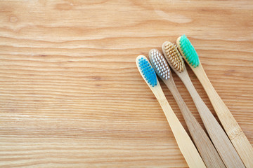 Zero waste concept. Bamboo toothbrush on wooden background. Plastic free essentials, teeth care.