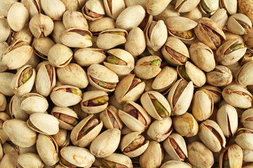 Background of salted pistachio nuts situated arbitrarily
