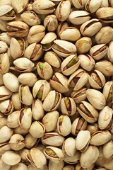 Background of salted pistachio nuts situated arbitrarily