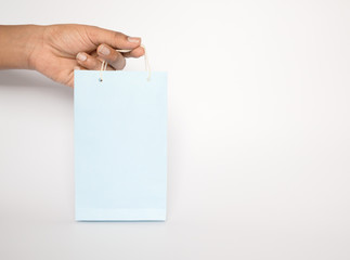 Hands holding Colorfull empty blue color Paper shopping bag on isolated background.