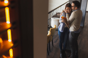 Man giving flowers to a woman