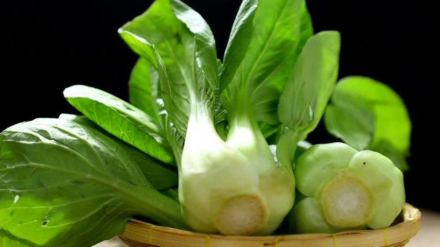 bok choy vegetable in a basket rotated on table in 4k resolution