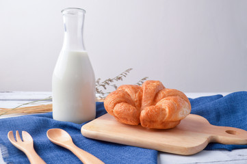 Bread and milk  for breakfast on wooden background