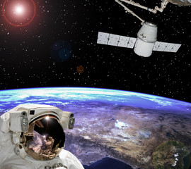 Obraz na płótnie Canvas Astronaut staring at the spaceship. Scene above earth. The elements of this image furnished by NASA.