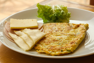 Omelet with cheese and salad