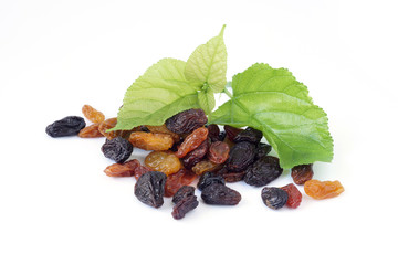 Raisins or Dried grapes mix color black, red, green with mulberry leaves isolated on white background