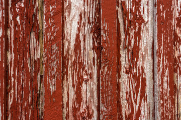 Old wood with peeling red paint texture