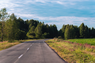 Perfectly smooth asphalt road in the countryside before sunset