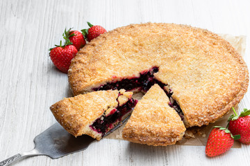 Homemade whole berry tart on white table