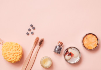Solid Conditioner, Toothy Tabs, Bamboo Toothbrush, Natural Washing Sponge And Pressed Dry Shampoo on Light Color Table