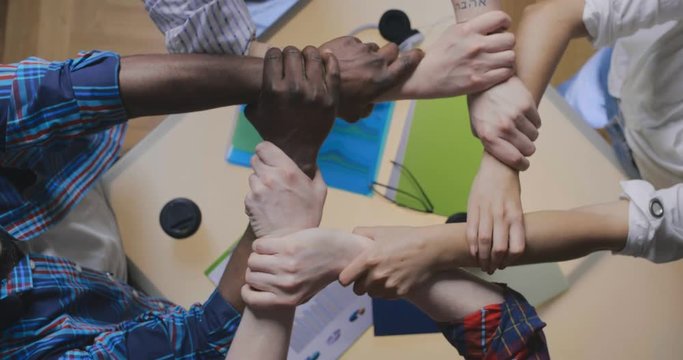 Friends with stack of hands