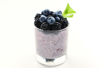 Chia pudding with mint, blueberry, blackberry on a white background. Space for text or design.