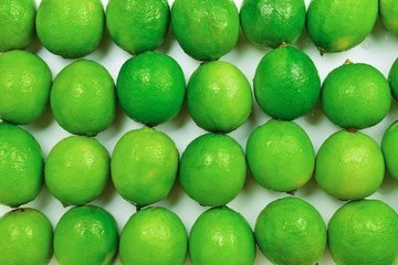 Many fresh limes on white background.