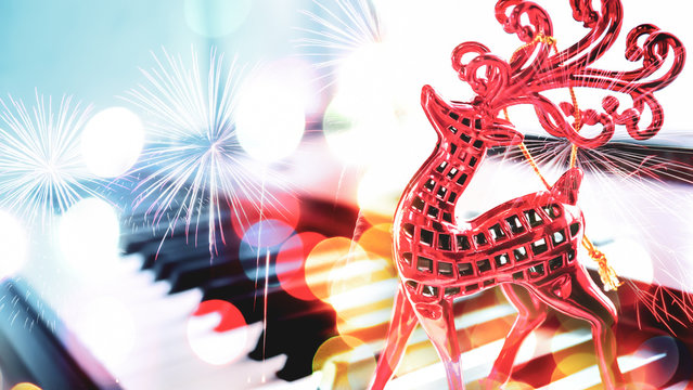 reindeer Christmas decoration and blurred piano background for new year and Christmas concept