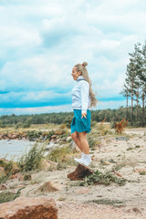 beautiful, slim woman with blonde pigtails resting, running, jumping on the shore of the sea.  vacation, joy, happiness, rest