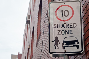 Limit of 10kmph shared zone traffic sign on metal pole