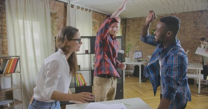 Office workers celebrating successful deal