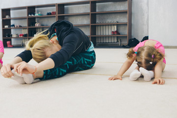 little girl engaged in recreational gymnastics. sports exercises and stretching: athletics