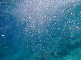 Abstract background of underwater bubbles in the Aponissos beach, Agistri island, Saronic Gulf, Attica, Greece.