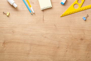 Modern school supplies on wooden desk table background. Back to school concept. Flat lay, top view. - Powered by Adobe