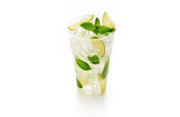 Fresh cold lemonade with soda, ice cubes, mint and lime on white background