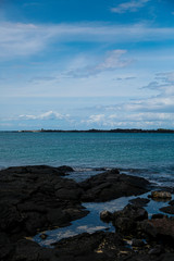 Lava beach in Hawaii with blue sky