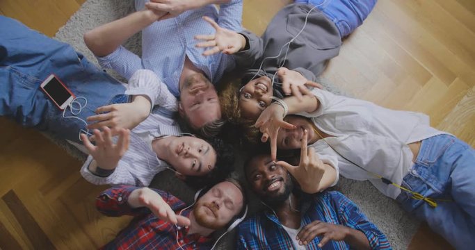 Friendly coworkers lying in circle