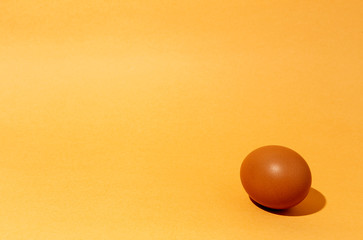 Fresh raw eggs on brown background