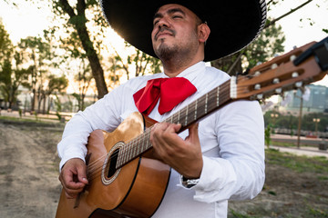 Mexican musicians mariachi playing the guitar