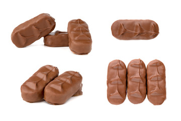 Chocolate bars on a white background. Chocolate candies with coconut flakes close-up.