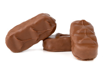 Chocolate bars on a white background. Chocolate candies with coconut flakes close-up.