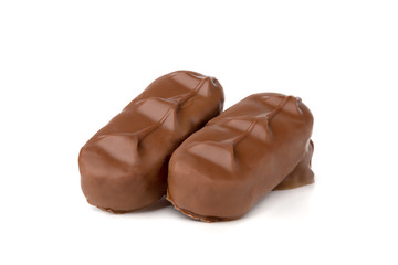 Chocolate bars on a white background. Chocolate candies with coconut flakes close-up.