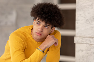 Pensive teenager with afro hairstyle
