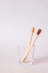 Bamboo toothbrush on blue background. Zero waste, ecological concept.