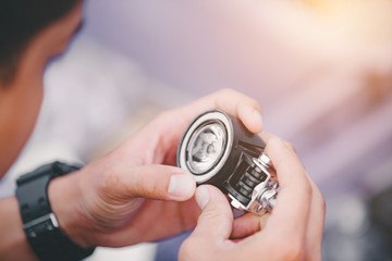 Young men are buying motorcycle headlights and accessories at the market